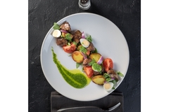 Image Fine dining dish with meat and eggs.