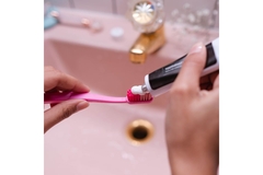 Image Person Putting Toothpaste On Toothbrush