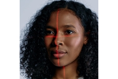 Black woman with two lines of light crossing her face.