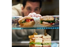 Sandwiches in paper bags in bakery.