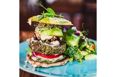 A colorful plant-based burger on a blue plate.