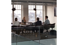Image A group of people gathered in a board room.