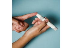 Image A hand poking their finger with a diabetes test.