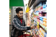 Image Man choosing dairy products at supermarket.