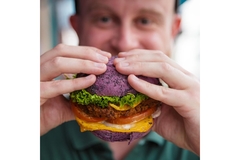 Image Man eating a plant-based burger.