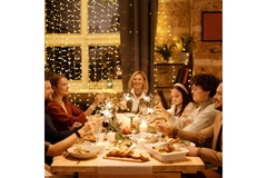 A family having Christmas dinner at the table.