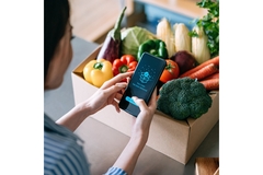 Image Woman makes delivery on phone.