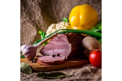 Vegetable is placed around a piece of meat.