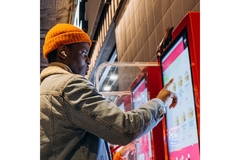 Image Man choosing a meal from a self-service canteen.