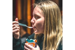 Image A teenager eats a school meal.