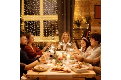 Family around a festive table, enjoying an elaborate meal for the holidays.