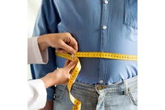 Image Measuring fat around a man's belly.