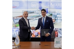 Image Two men in suits shaking hands after a business deal.