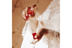 A woman spraying perfume on her wrist.