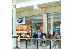 Image People lining up outside of a Boots store.