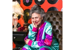 An older woman sitting in a large leather chair.