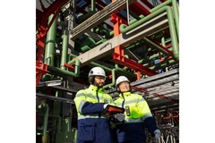 Image Workers standing in new plastic recycling facility.