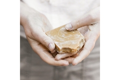 Image A man holding a bar of soap.