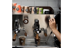 Image Person making coffee-to-go in cafe.