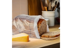 Image A bag of bread is placed on a kitchen table.