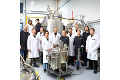 Image A bioreactor plant with scientists standing near it.