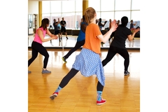 Image A group of people dancing in a gym.