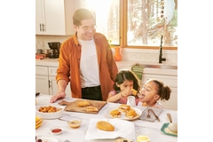Image Family cooking breakfast in the kitchen with mycelium-based meat alternatives.
