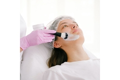 Image A women getting a face mask put on her face.