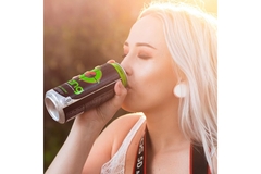 Young woman drinks energy drink.