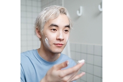 A man moisturizing his face.