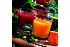Two cups of juice are put on a black table.