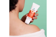 Image A woman putting a roller product on her shoulder.