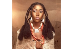 Nigerian woman wearing traditional fashion with modern makeup.