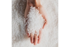 Image White PLA resins in hands.
