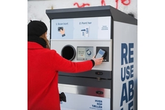 Woman depositing packaging.