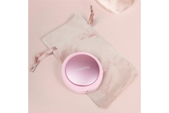 Mavian's face massager on a pink background.