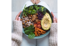Plate with vegetarian food in woman hands.