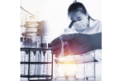 Image Scientist looking through microscope.