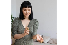 A woman spraying perfume on her wrist.