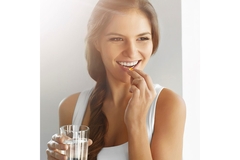 Woman taking supplement.