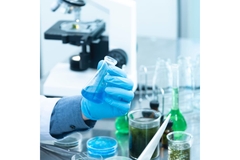 scientist wearing glove holding vial