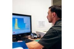 Image man looking at a packaging design on a computer screen