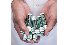 hands holding several chapsticks.