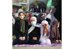 Image Girls in Gaza sitting on the ground.
