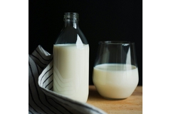 Image A glass of milk and a bottle of milk are put together.