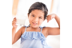 Image Girl drinks glass of milk.