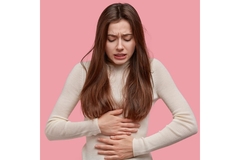 Woman hold her stomach in plain.