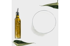 Image A bottle of oil is placed next to a large bowl of milk.