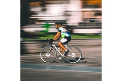 Man on a bike cycling very fast.