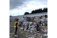 Image Woman standing in front of packaging wate.